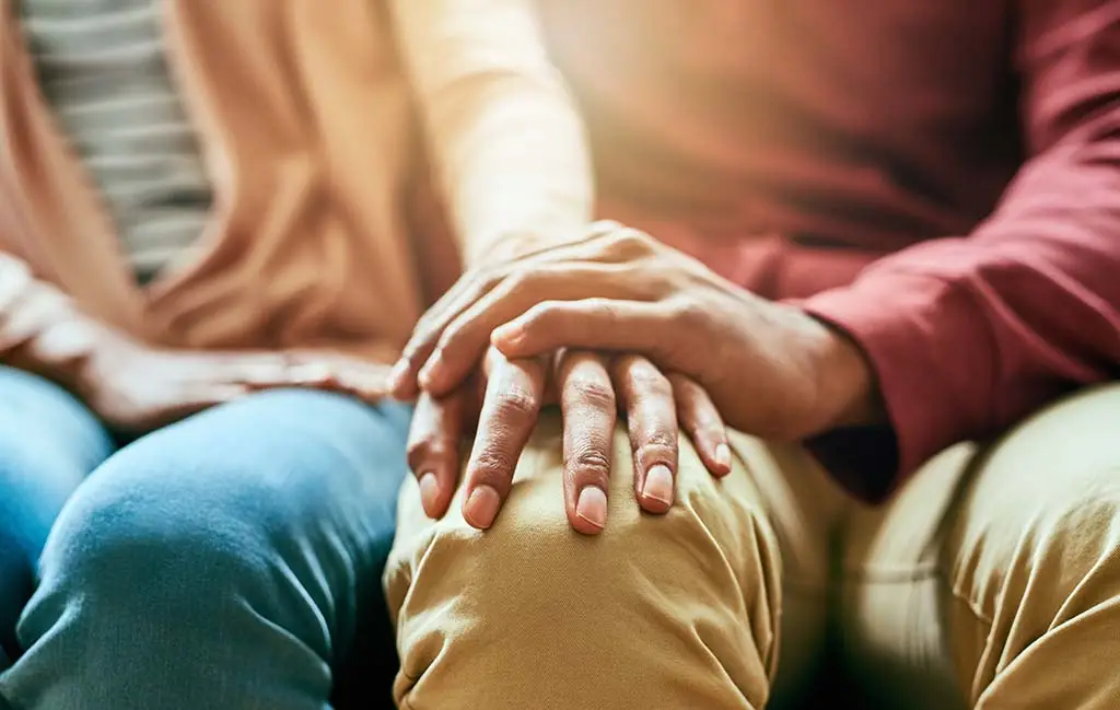 Someone supporting a loved one in their struggle.